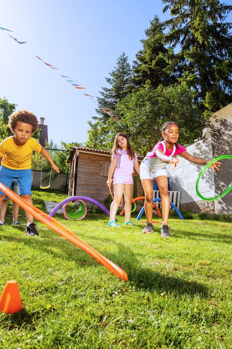 Group of Kids Playing ring toss Game with Hula hoops