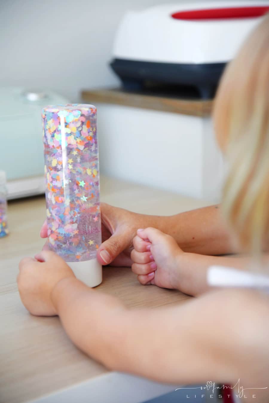 toddler playing with DIY calming bottle