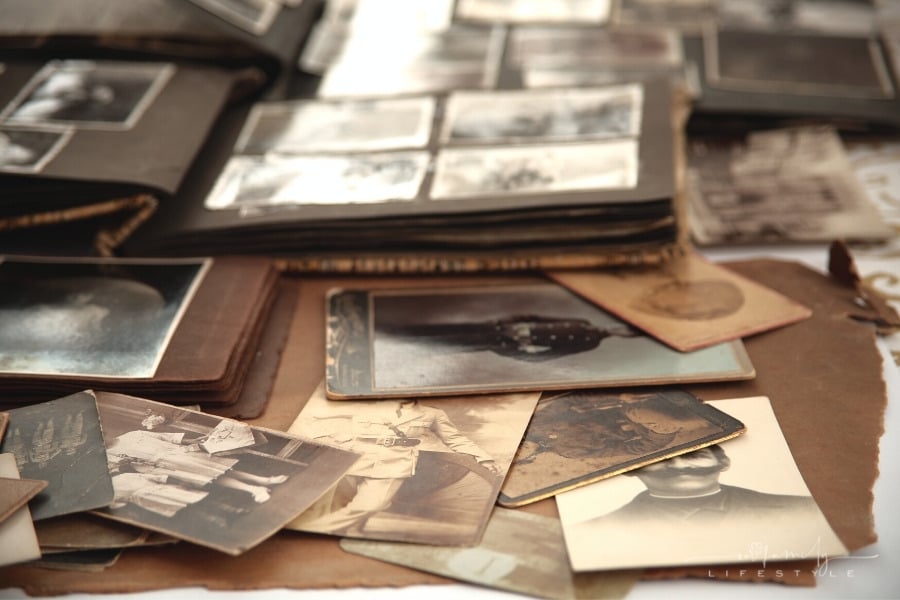 old photos and albums scattered across beige paper