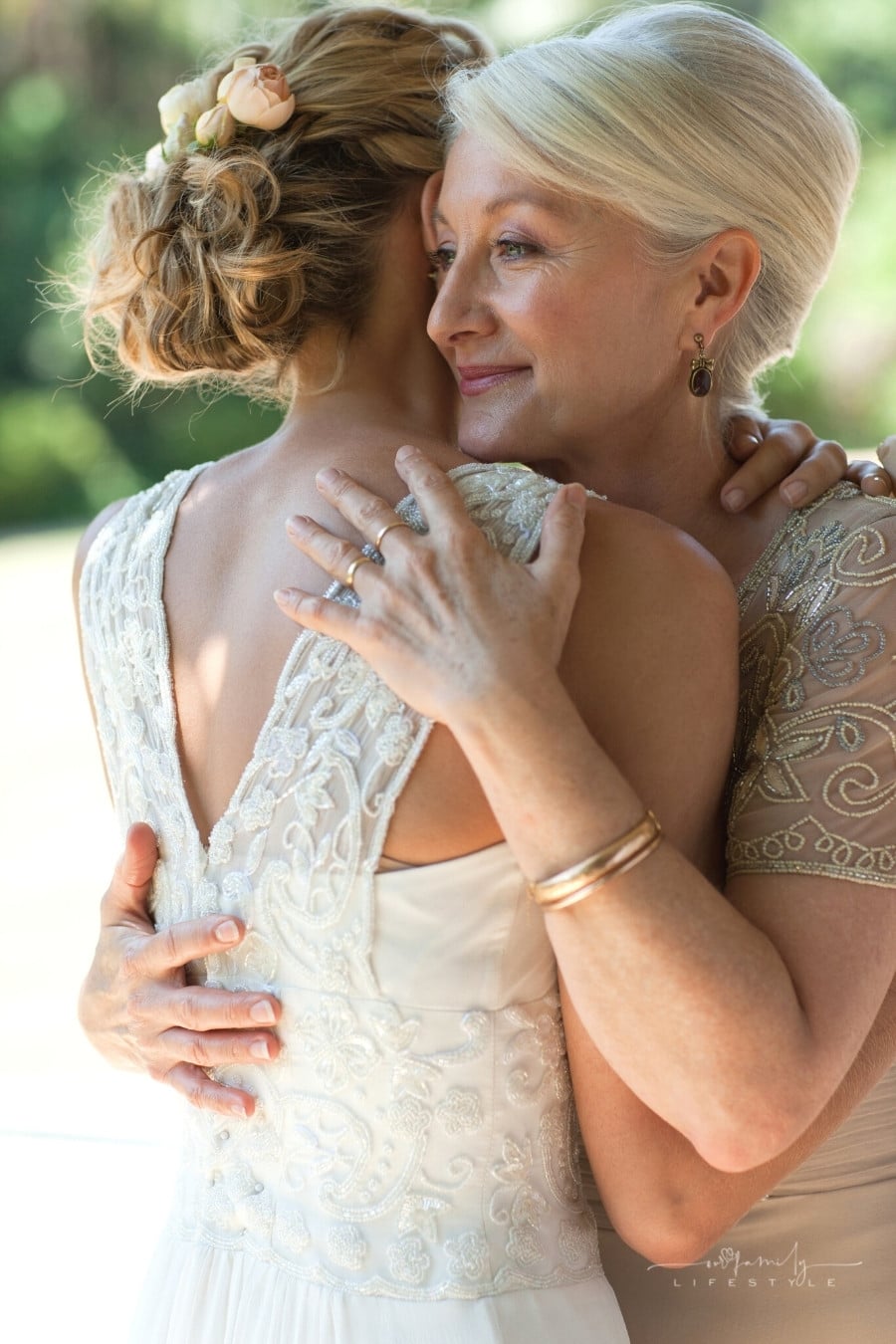 mother hugging bride before wedding