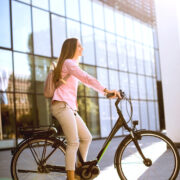 young woman riding an e-bike on a sunny day