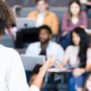 female professor giving lecture to college students