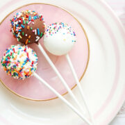 overhead view of white and brown cake pops with sprinkles