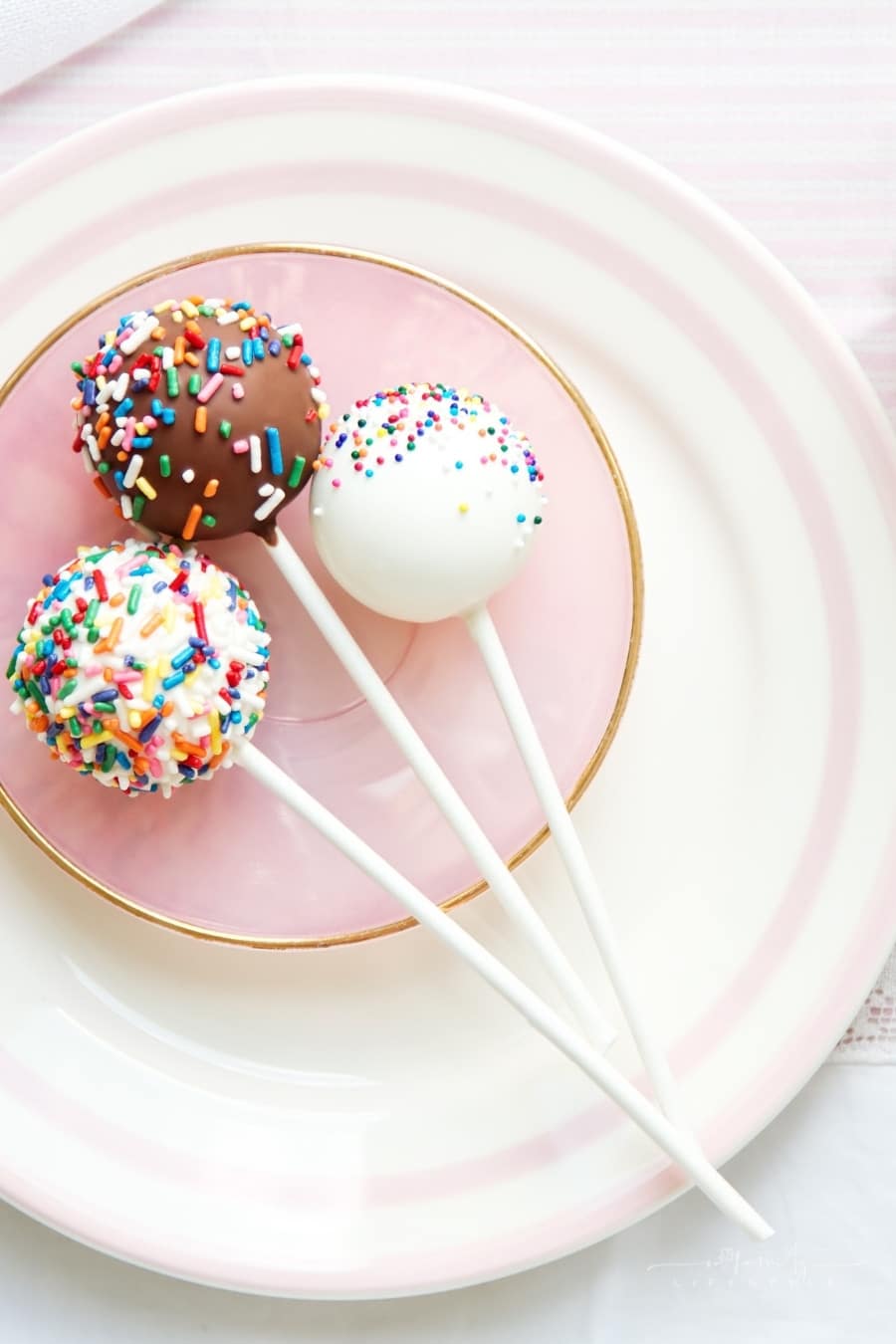 overhead view of white and brown cake pops with sprinkles