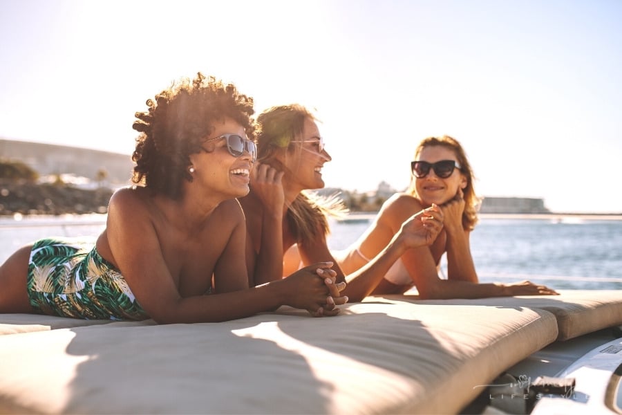 group of women sun bathing on a yacht deck