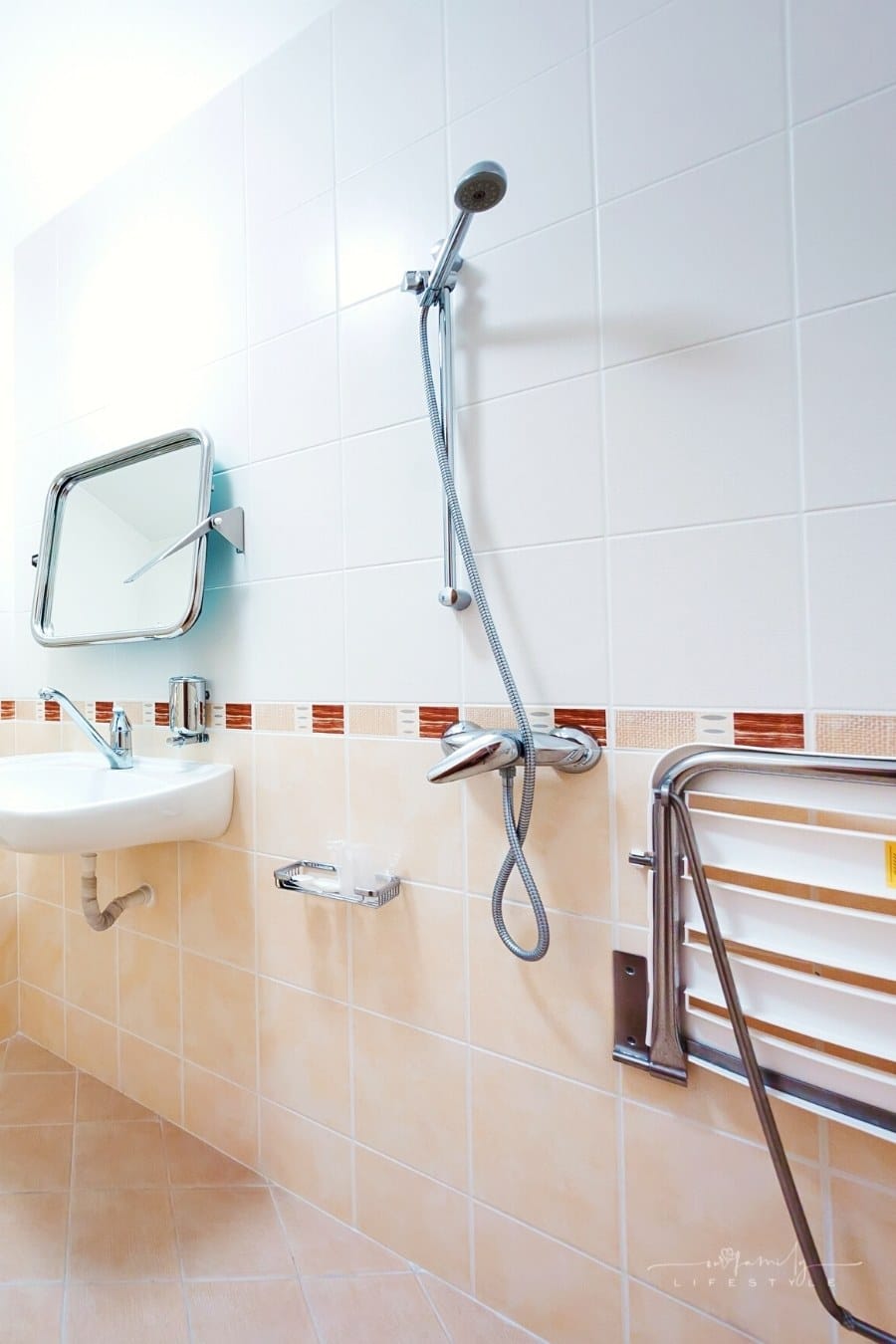 bathroom with grab bar and shower seat