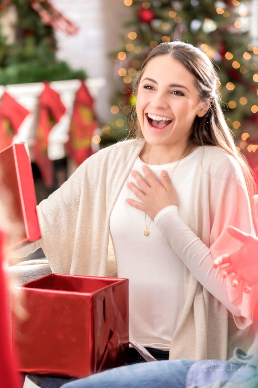 woman excited while opening Christmas gift