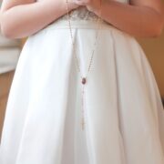 young girl holding rosary during first holy communion