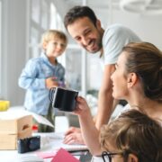 parents working in home-based office with their two young sons