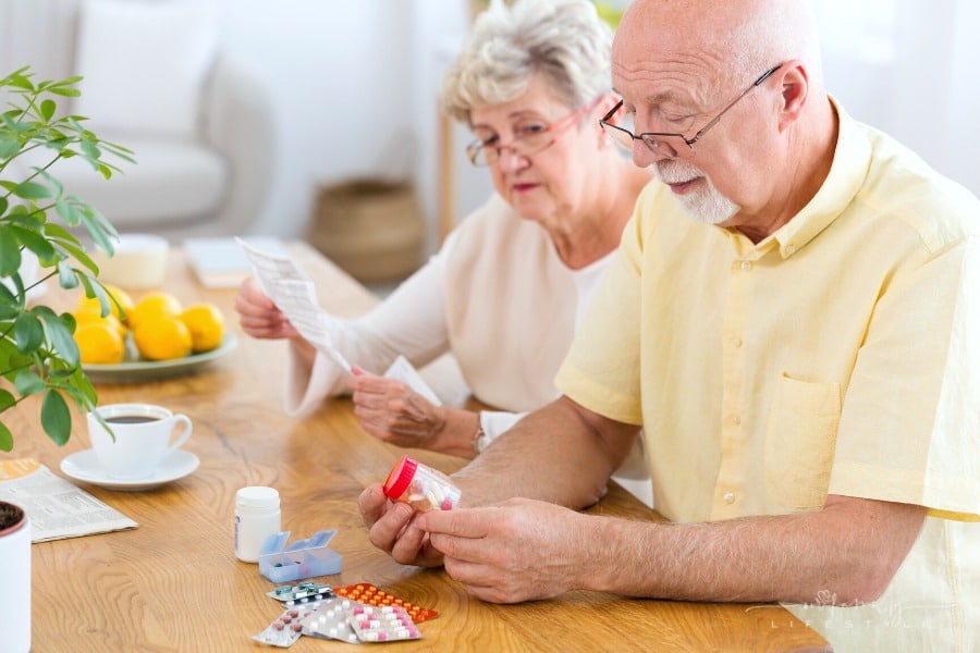 elderly couple reading prescription labels