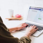 woman logging into Facebook on a laptop