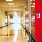 empty school hallway filled with red lockers