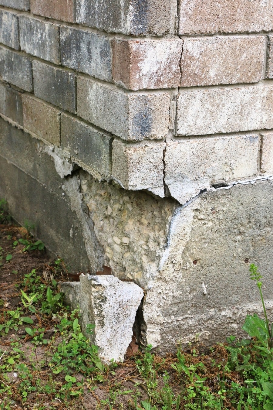 settlement (collapse) on exterior of house foundation