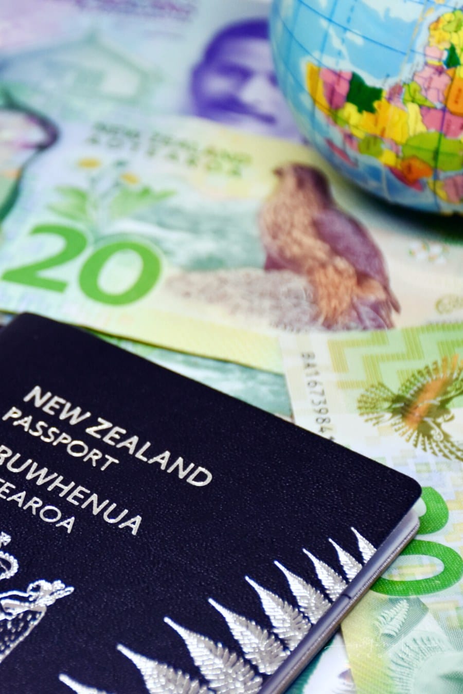 New Zealand passport on top of New Zealand dollars bank notes