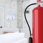 fire extinguisher hanging on wall near living room fireplace