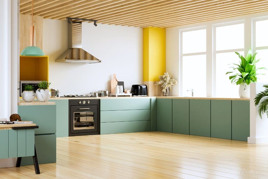 modern kitchen with sage green cabinets, yellow and wood accents