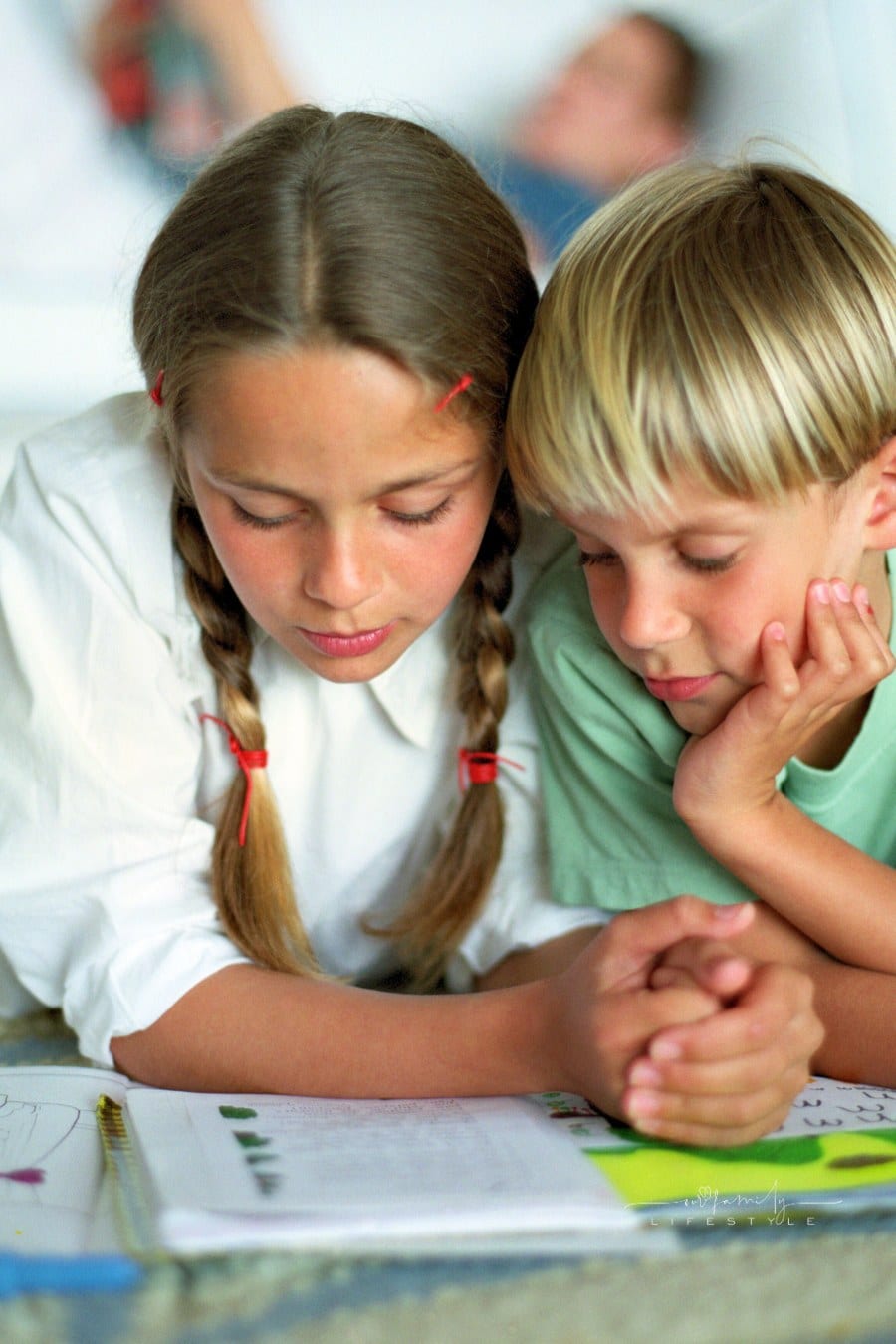 Brother & Sister Reading a Book Together