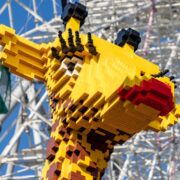 A picture of a giraffe made of Lego, on display next to the Tempozan Giant Ferris Wheel (Osaka).