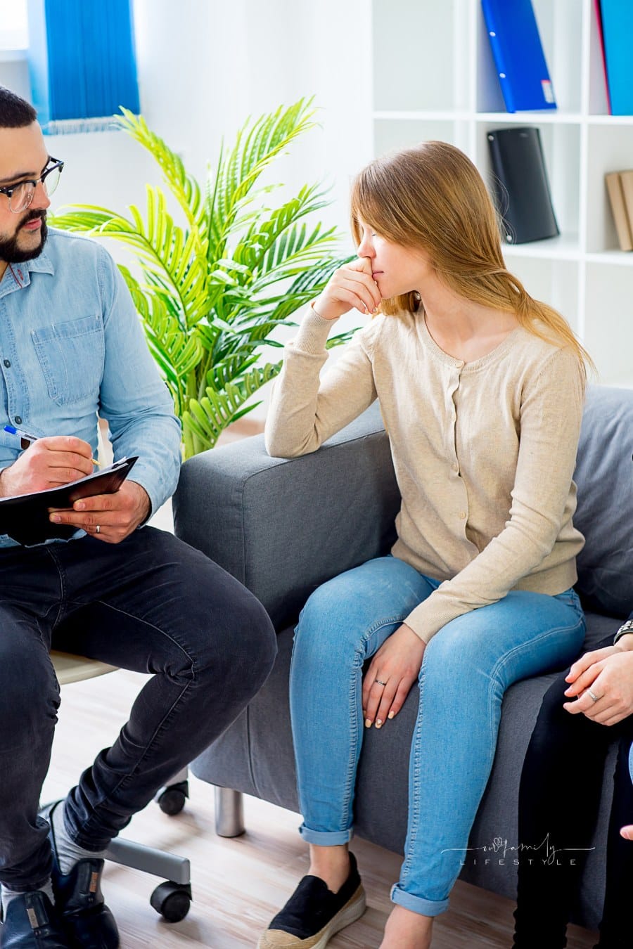 family with teen daughters in therapy session