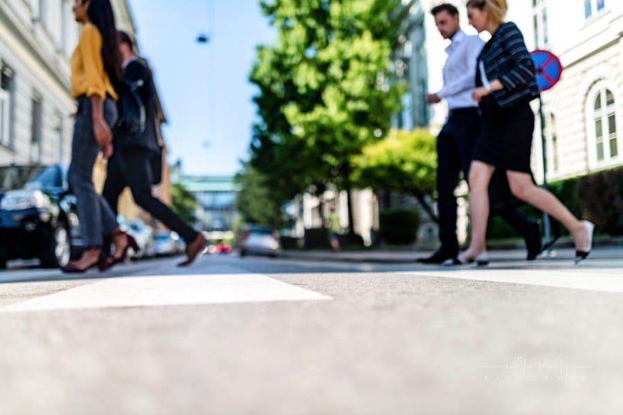 Business people walking on pedestrian crossing