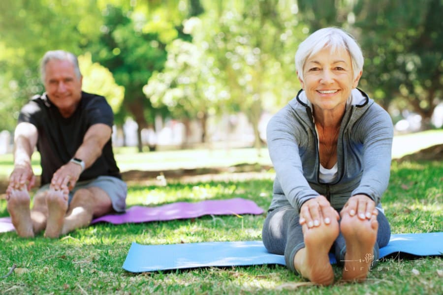 Portrait, fitness and senior couple in a park, yoga and meditation for wellness, workout and healthy lifestyle. Face, mature woman or old man outdoor, stretching and exercise for balance or fresh air.
