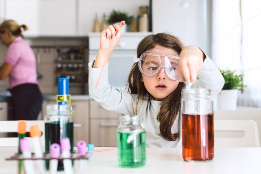 Child playing science in the kitchen