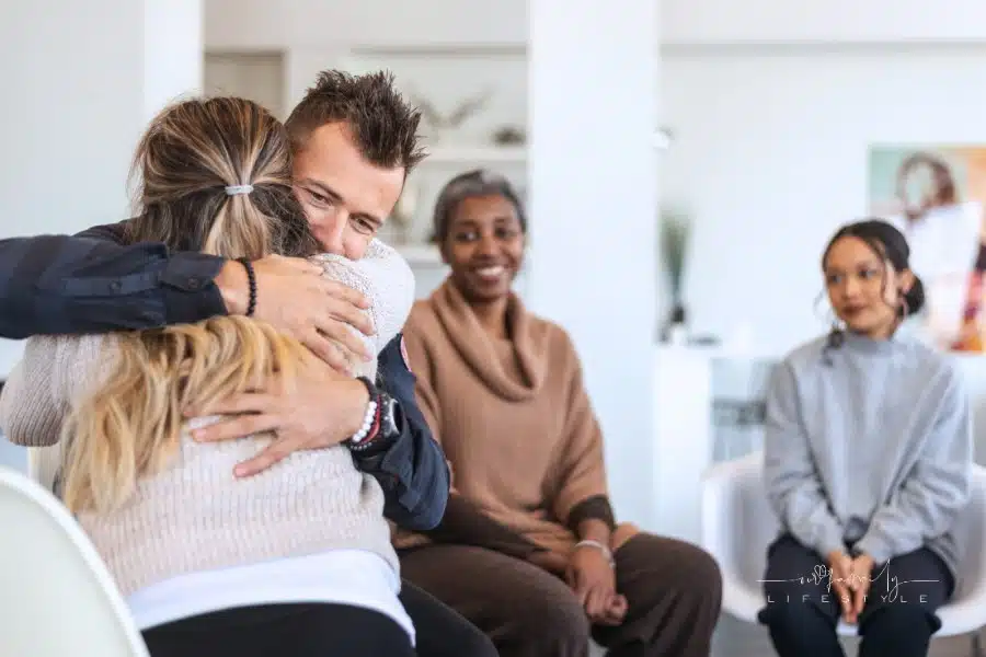 Husband and wife hug in group therapy session