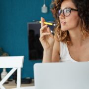 woman entrepreneur sitting at home thinking while on laptop