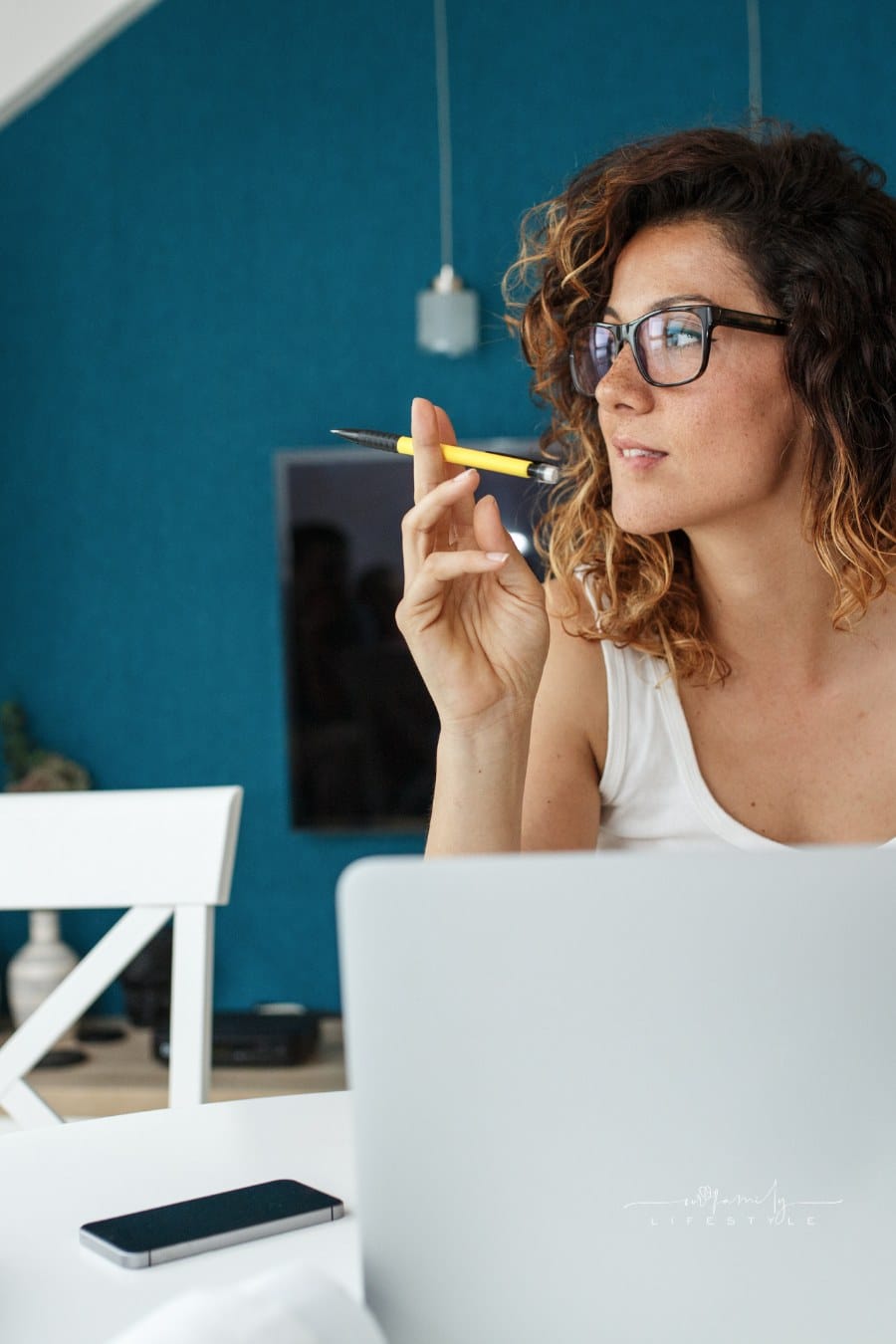 woman entrepreneur sitting at home thinking while on laptop