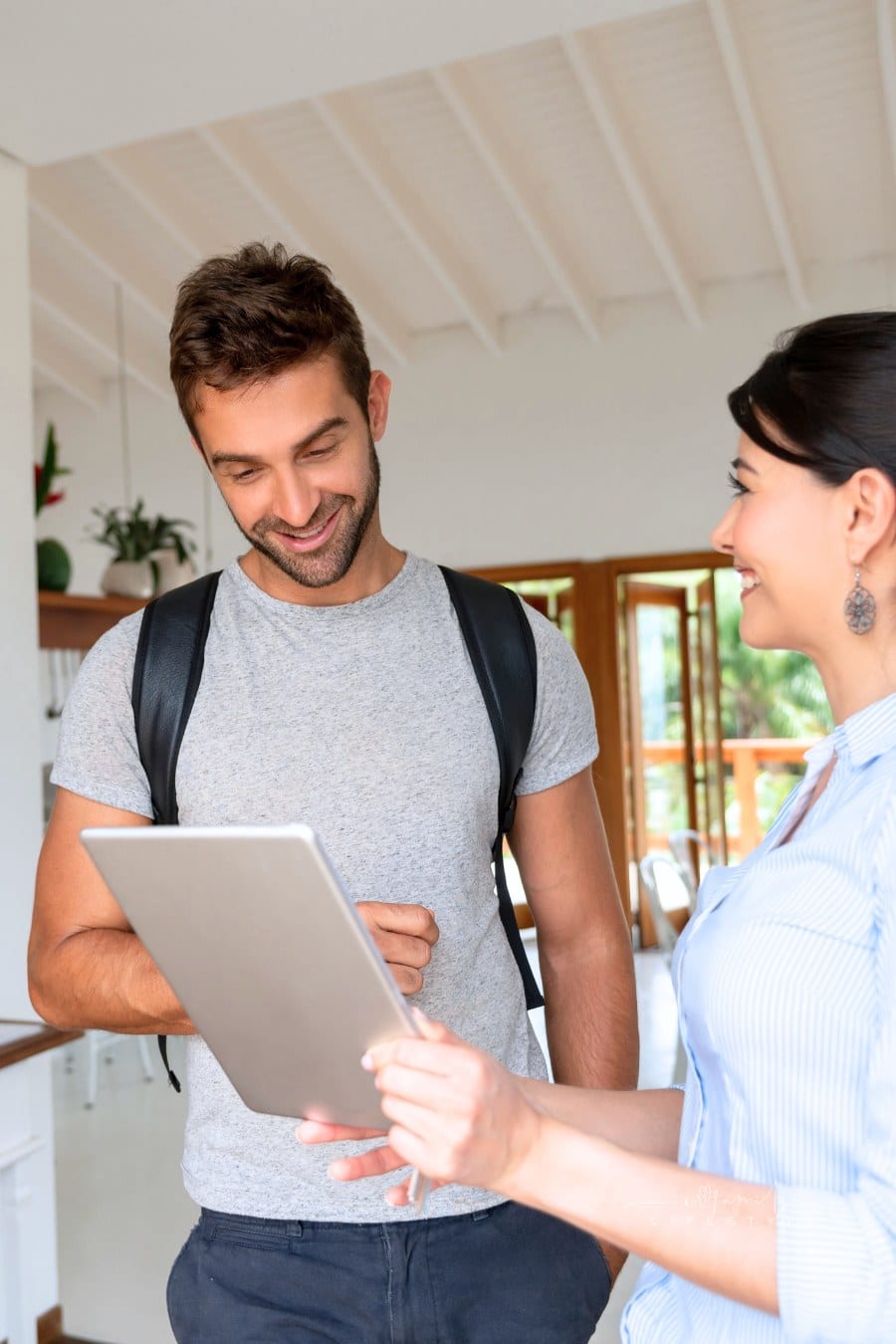 Portrait of a realtor showing a property to a client while holding a tablet in her hand