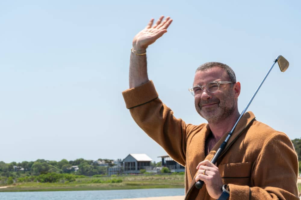 This image features Liev Schreiber portraying Tag Winbury. With a golf club in hand and a relaxed wave, Schreiber's character exudes confidence and charm, capturing Tag's wealthy, laid-back persona. His role adds layers of intrigue and complexity to the series, making him a central figure in the Winbury family drama.