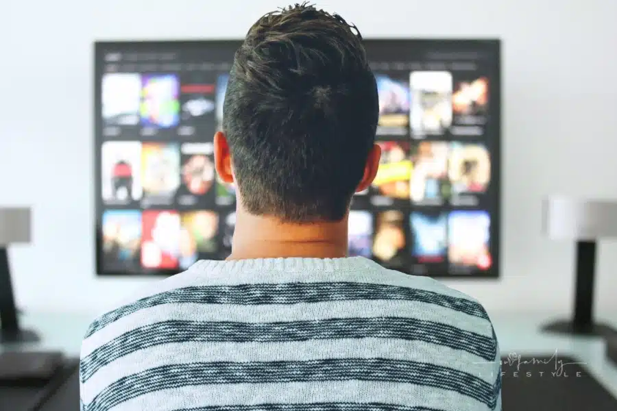 backview of man watching TV