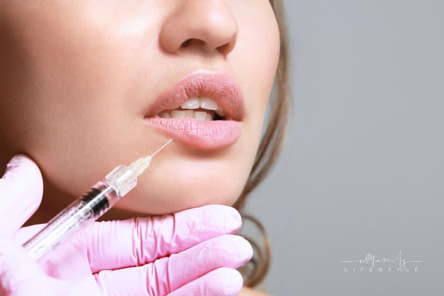 Young Woman Receiving Injection of Filler in Lips, Closeup