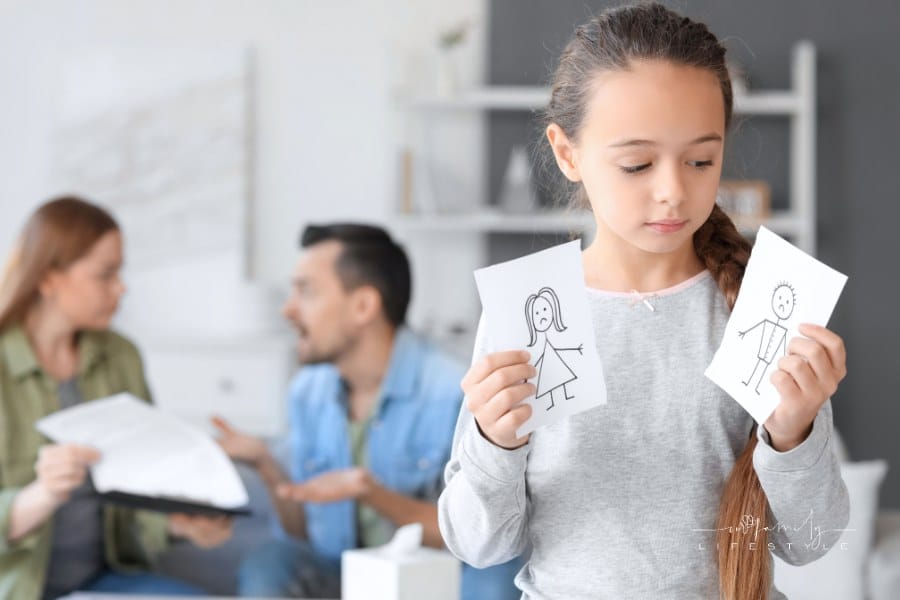 Sad Little Girl with Torn Drawing of at Home. Divorce Concept