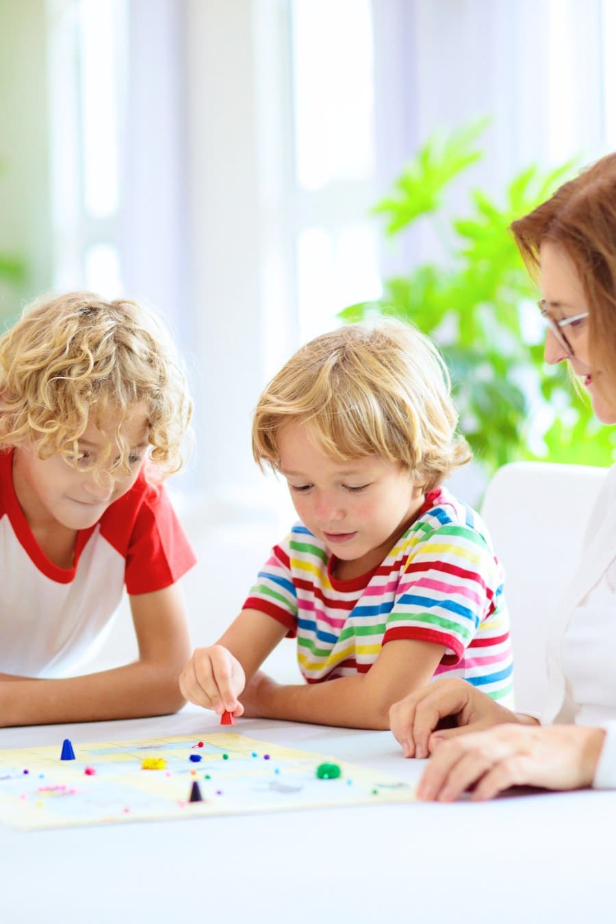 Family with Kids playing board game