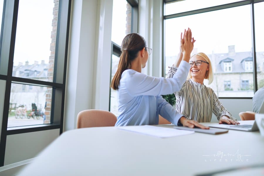 Female Entrepreneurs Doing a High Five During Meeting