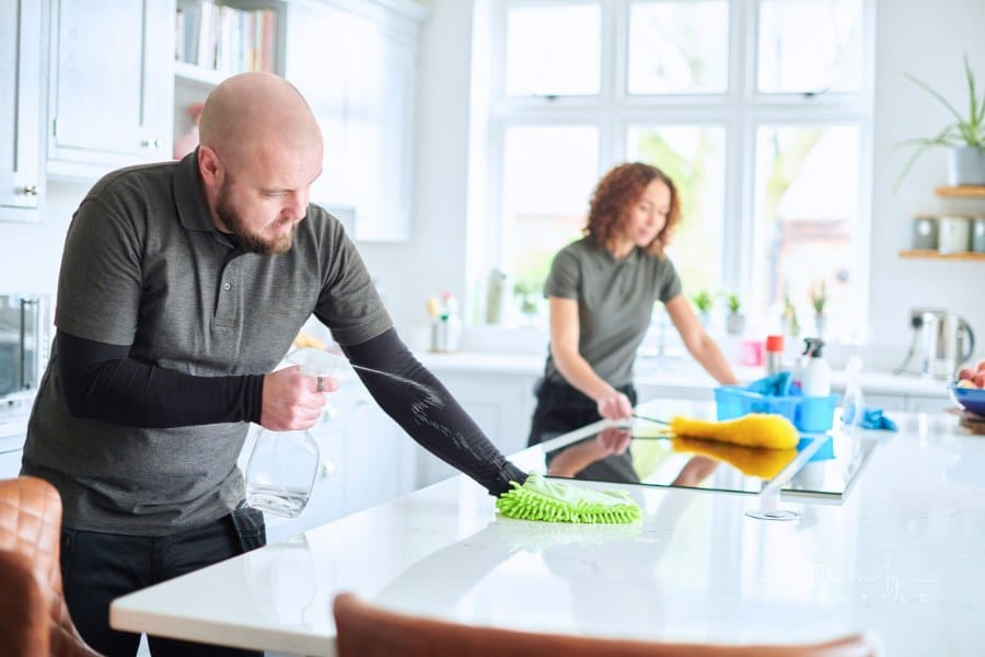 professional cleaning team in residential kitchen