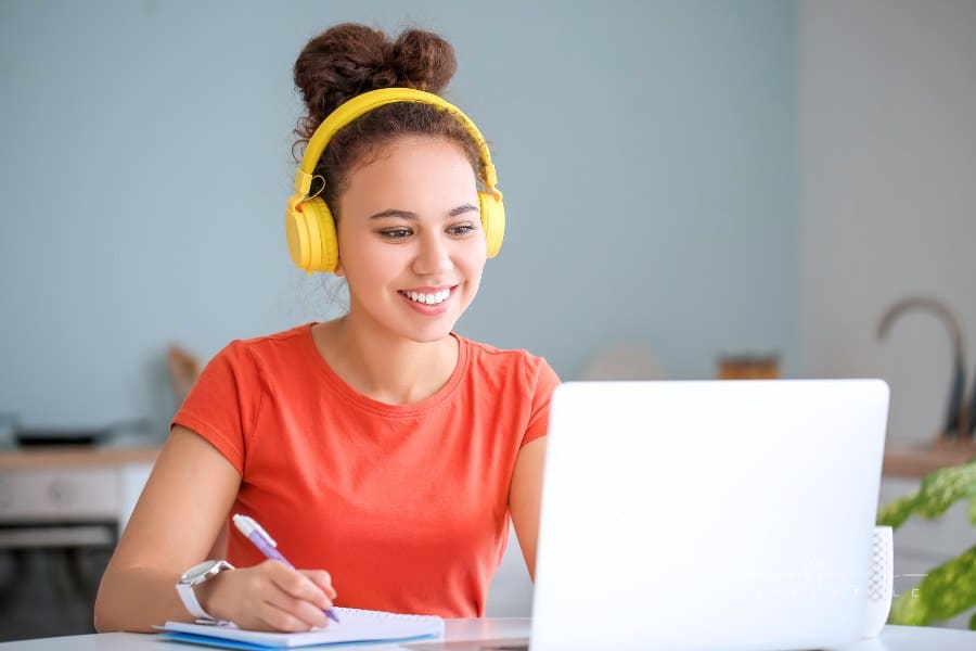 Young Woman Using Laptop for Online Learning at Home