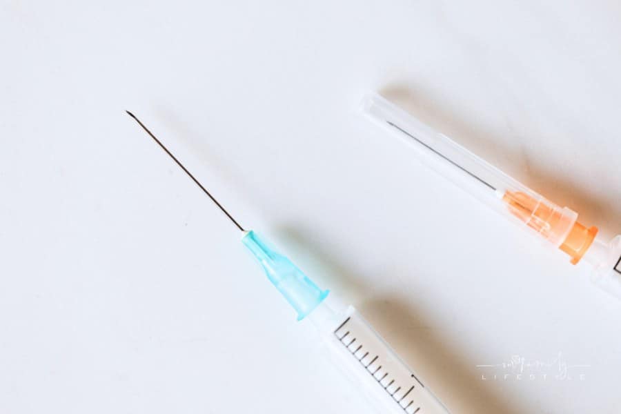 Syringes with needles on table in clinic