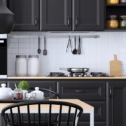 Modern Scandinavian kitchen and dining room with matte black black shaker cabinet design